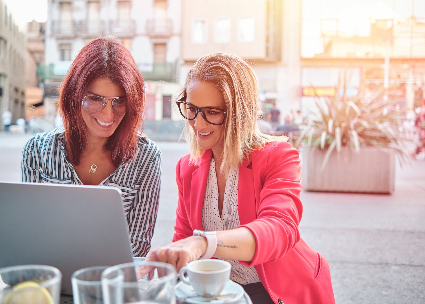 Two Businesswomen Working Outdoors with Laptop